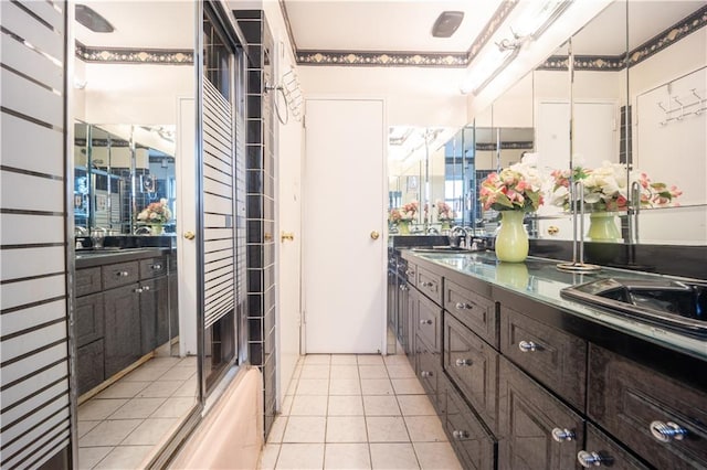 full bathroom featuring vanity, tile patterned floors, and a shower