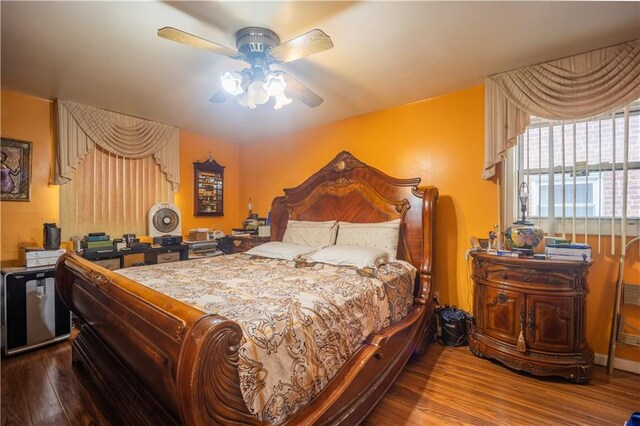 bedroom with wood-type flooring and ceiling fan