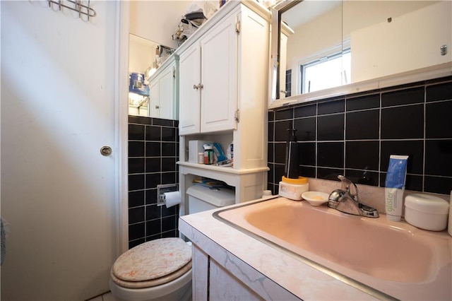 bathroom featuring tasteful backsplash, vanity, toilet, and tile walls