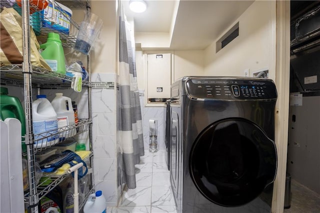 laundry area featuring independent washer and dryer and tile walls