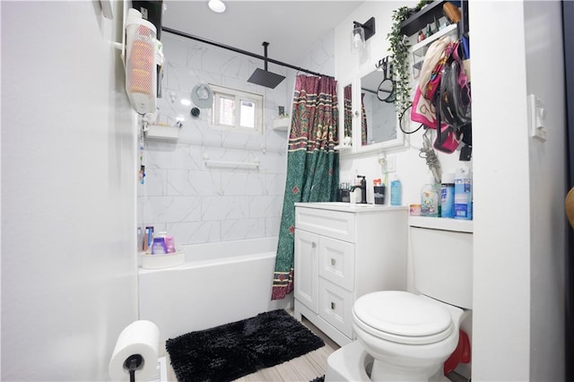 full bathroom with shower / tub combo with curtain, toilet, and vanity