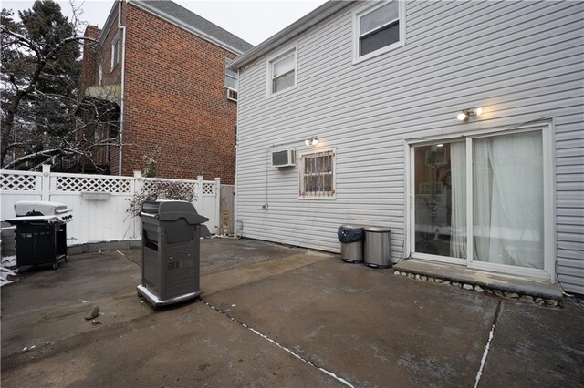 view of patio / terrace with a grill and a wall mounted air conditioner