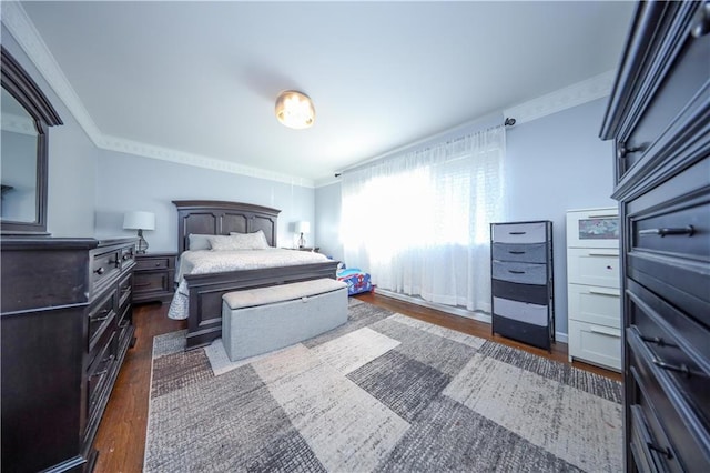 bedroom with crown molding and dark hardwood / wood-style floors