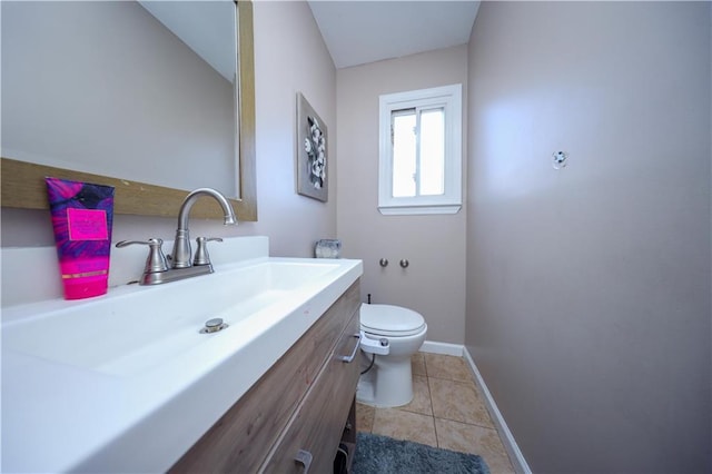 bathroom with tile patterned flooring, vanity, toilet, and lofted ceiling