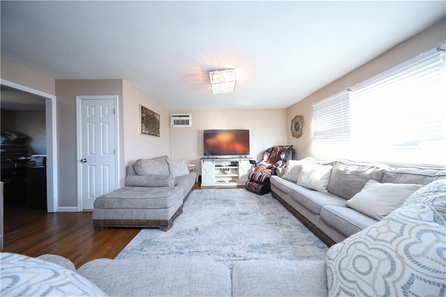 living room featuring dark wood-type flooring and a wall mounted AC