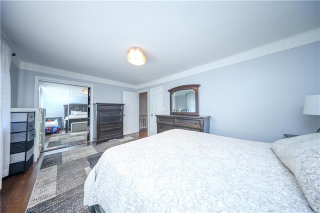 bedroom with ornamental molding and dark wood-type flooring