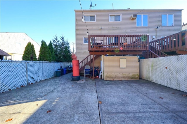 back of property with a patio and a deck