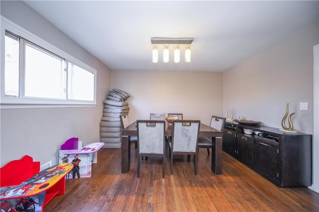 dining space with dark hardwood / wood-style flooring