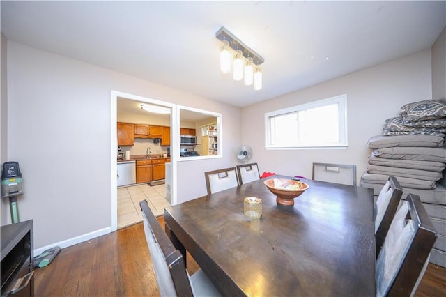 dining space featuring sink and light hardwood / wood-style floors