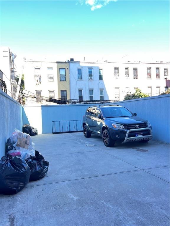 view of parking / parking lot with fence