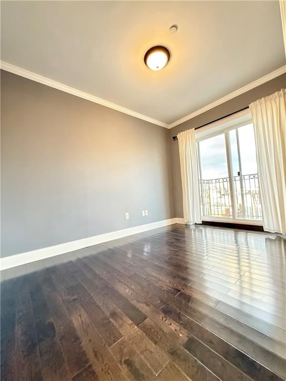 empty room with dark hardwood / wood-style floors and ornamental molding