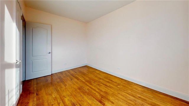 empty room with hardwood / wood-style flooring