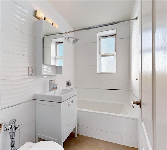 full bathroom featuring tile patterned floors, toilet, vanity, and tiled shower / bath