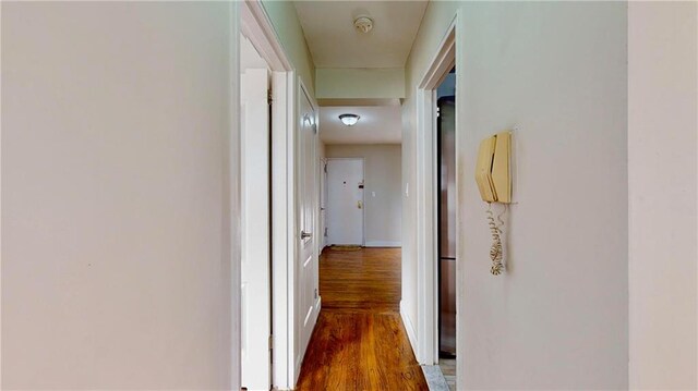 corridor with dark hardwood / wood-style floors