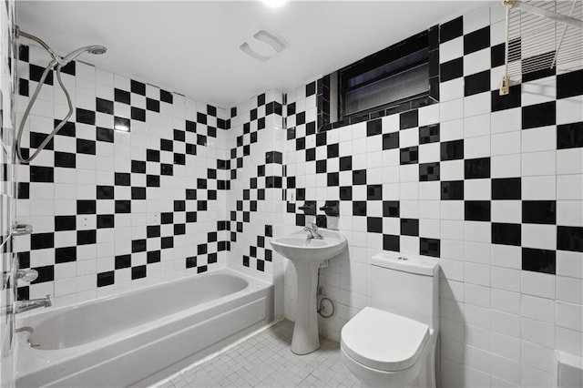 bathroom with tile patterned floors, tub / shower combination, tile walls, and toilet