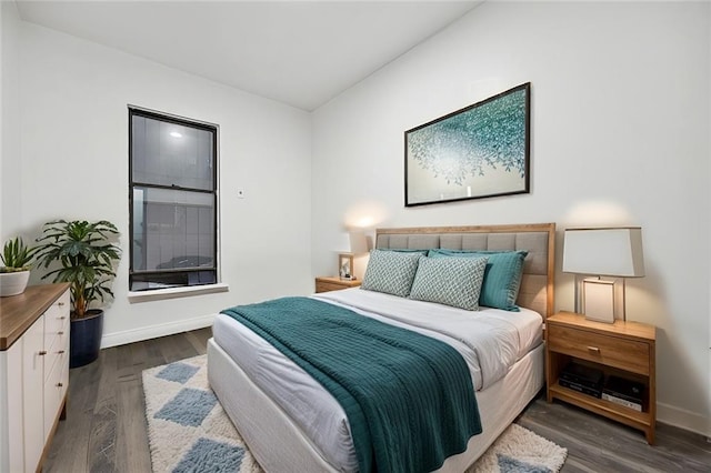 bedroom with dark wood-type flooring