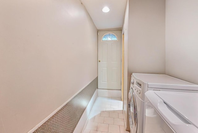 laundry room with light tile patterned floors and washing machine and clothes dryer