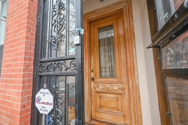 property entrance featuring brick siding