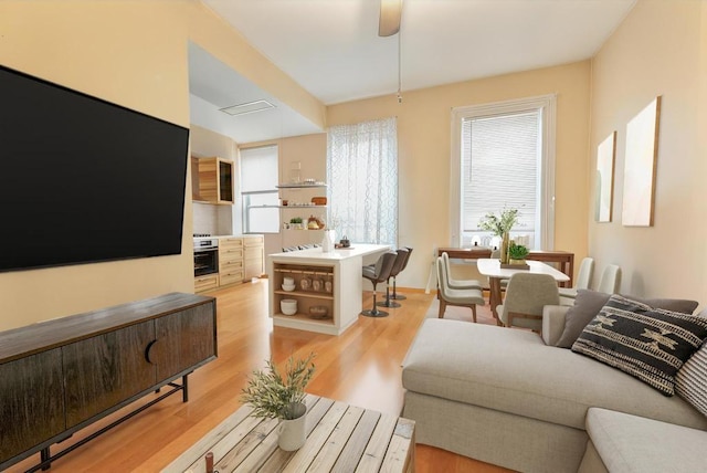 living room with ceiling fan and light hardwood / wood-style floors