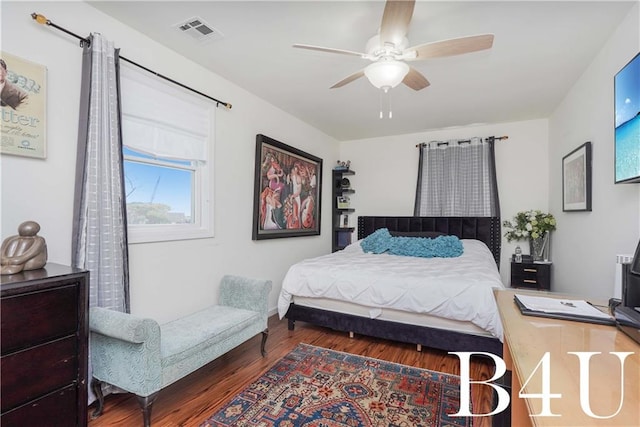 bedroom with ceiling fan and dark hardwood / wood-style flooring