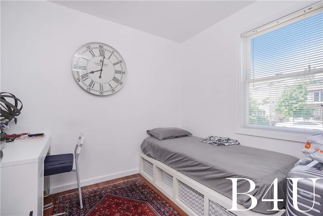 bedroom with hardwood / wood-style flooring