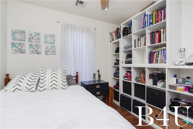 bedroom with ceiling fan and dark hardwood / wood-style flooring