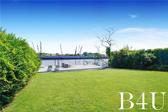 rear view of property featuring a yard and a water view