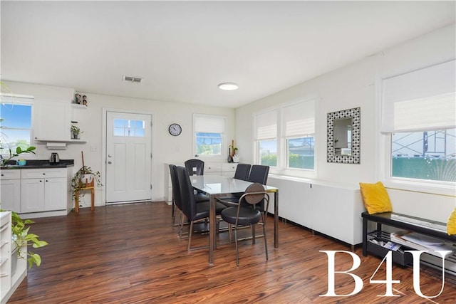 dining space with dark hardwood / wood-style floors