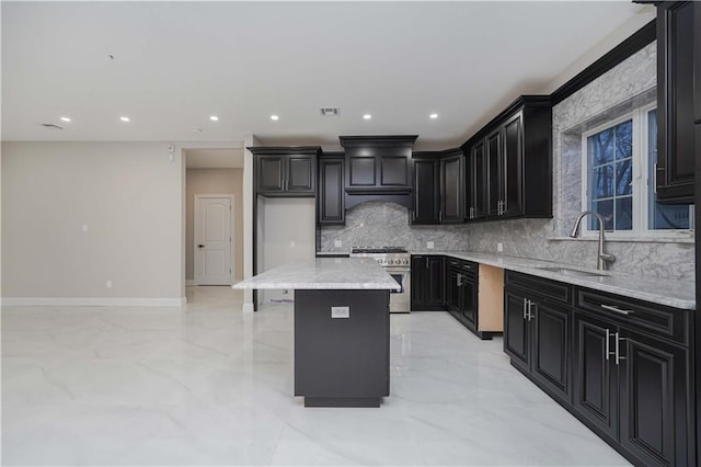 kitchen featuring a kitchen island, sink, high end range, decorative backsplash, and light stone countertops