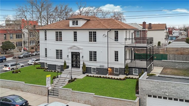 view of front of property featuring a front yard, a residential view, and stucco siding