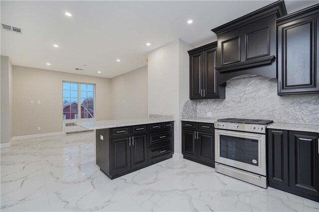 kitchen with backsplash, gas stove, kitchen peninsula, and premium range hood