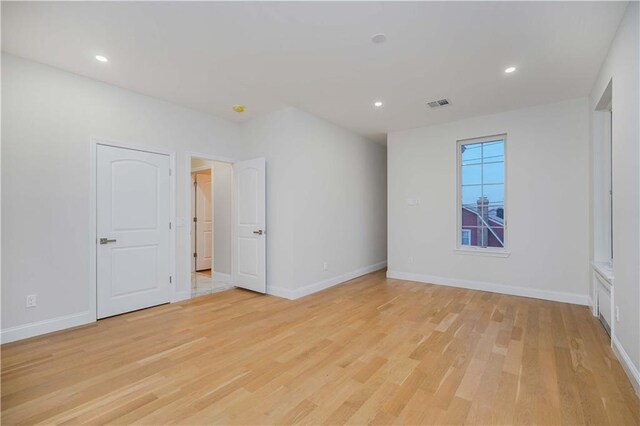 unfurnished room with light hardwood / wood-style flooring