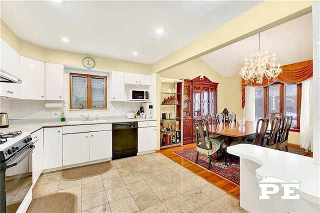 kitchen with white microwave, black dishwasher, light countertops, range with gas cooktop, and an inviting chandelier