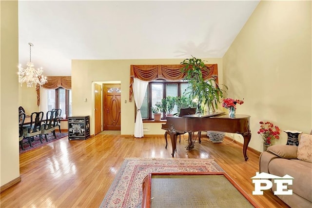 interior space featuring a notable chandelier, a wealth of natural light, and wood finished floors