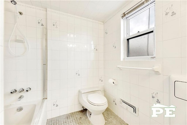 full bathroom featuring toilet, tile patterned flooring,  shower combination, and tile walls