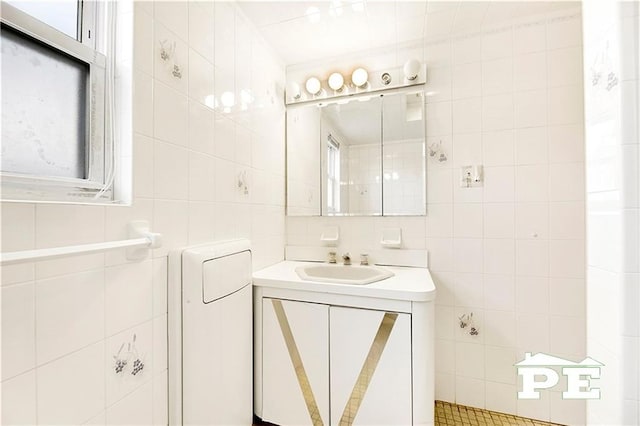 bathroom with tile walls and vanity