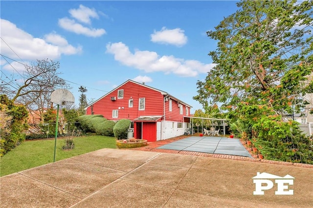 view of side of property featuring a lawn and a patio