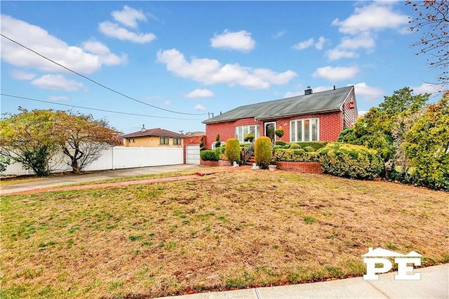 ranch-style house with a garage, brick siding, fence, and a front lawn