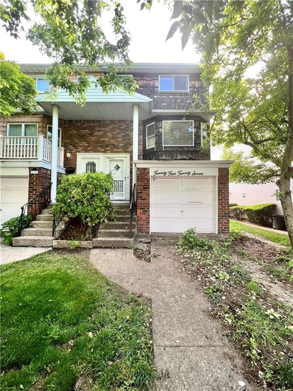 view of property with brick siding, driveway, and a garage