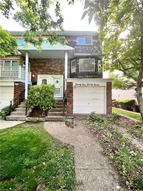 2427 E 72nd St, Brooklyn, NY 11234 - view of front of property with brick siding, an attached garage, concrete driveway, and covered porch