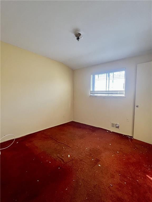 spare room with visible vents and carpet floors