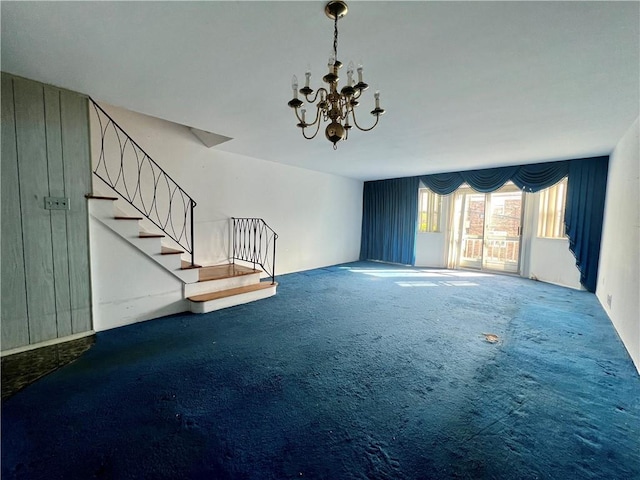 unfurnished living room featuring stairway, carpet, and a chandelier