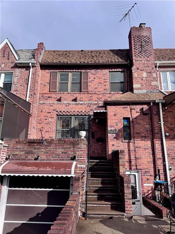 view of property featuring brick siding