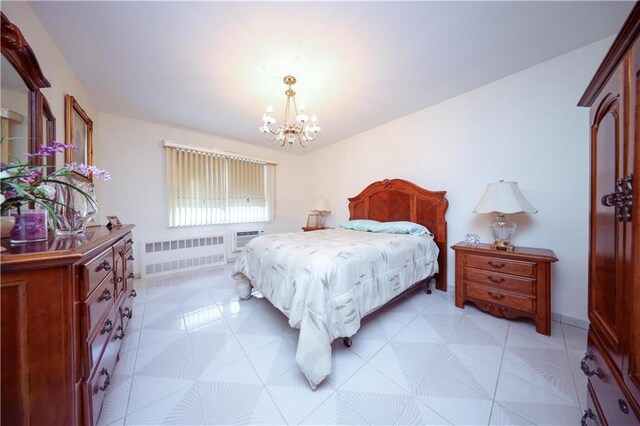 tiled bedroom featuring a wall mounted air conditioner, a notable chandelier, and radiator