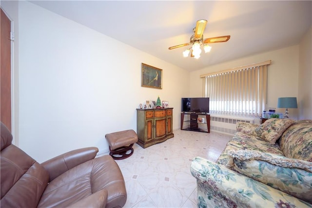 living room featuring ceiling fan and radiator heating unit