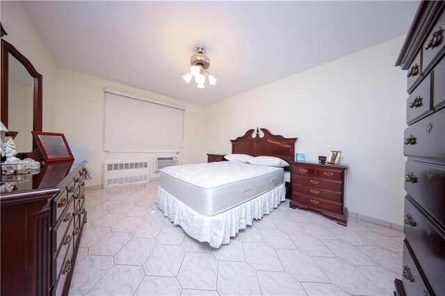 bedroom with an AC wall unit, ceiling fan, and radiator heating unit