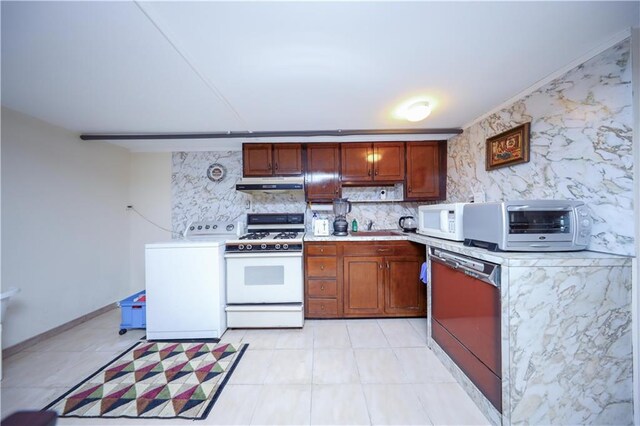 kitchen with white appliances, washer / clothes dryer, tasteful backsplash, and sink