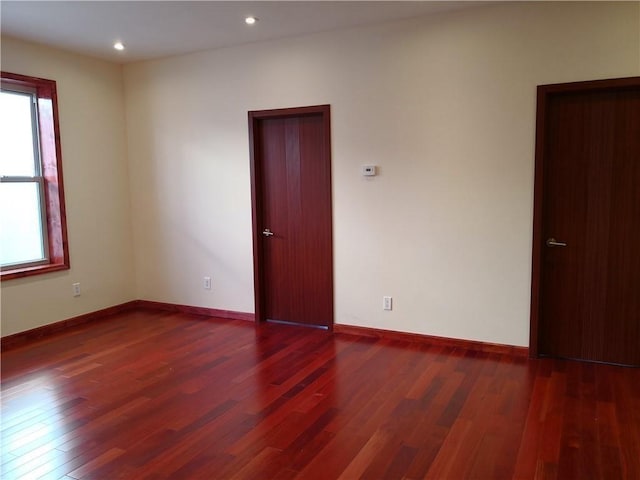 unfurnished room with dark hardwood / wood-style floors