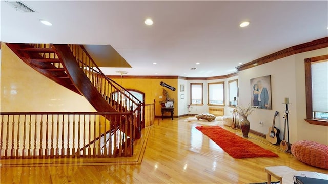 interior space featuring hardwood / wood-style floors and crown molding