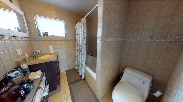 full bathroom featuring shower / bath combo, vanity, tile patterned flooring, toilet, and tile walls